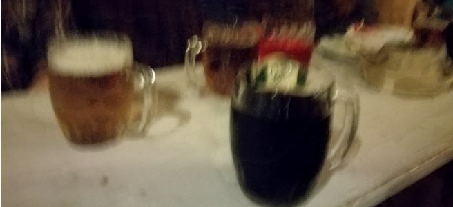 blurry photo of large glasses of beer.