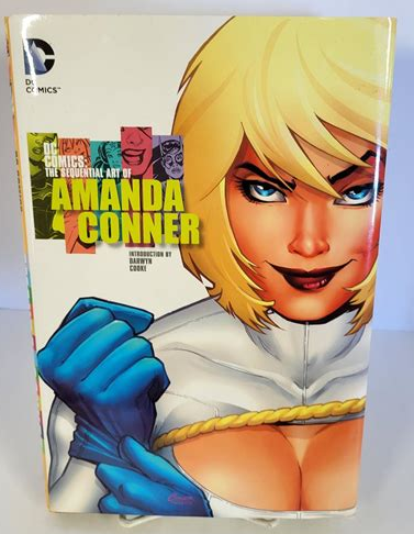 Cover of the sequential art of Amanda Conner. It shows and drawing of the super hero power girl pulling on her glove and smirking at the viewer. Her costume is white with a gold rope holding on her cape. Also the boob window. There is a hole in the costume to show the cleavage of her massive breasts.