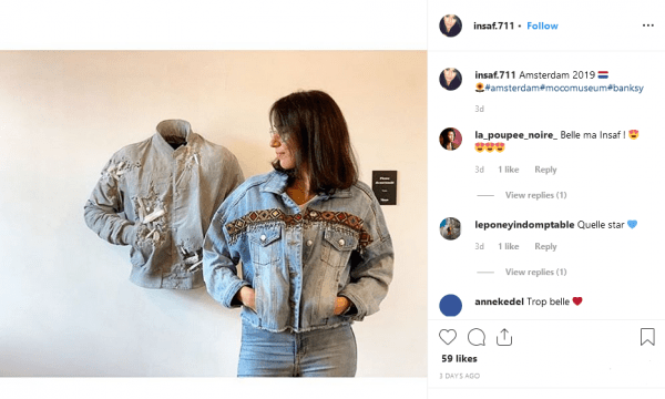 Nicely framed photo of a woman wearing a denim jacked echoing the pose of the calcified denim jacket artwork by Daniel Arsham. The Instagram post description includes #Banksy.