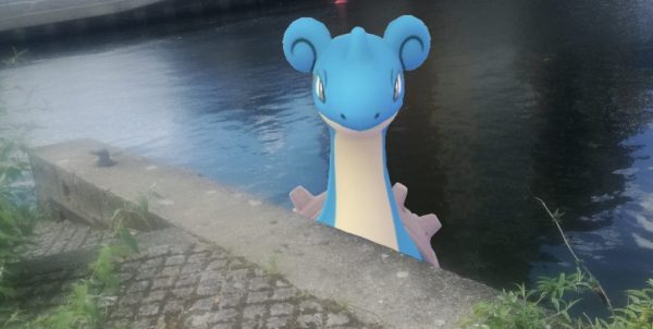Lapras in the river peaking over the pathway